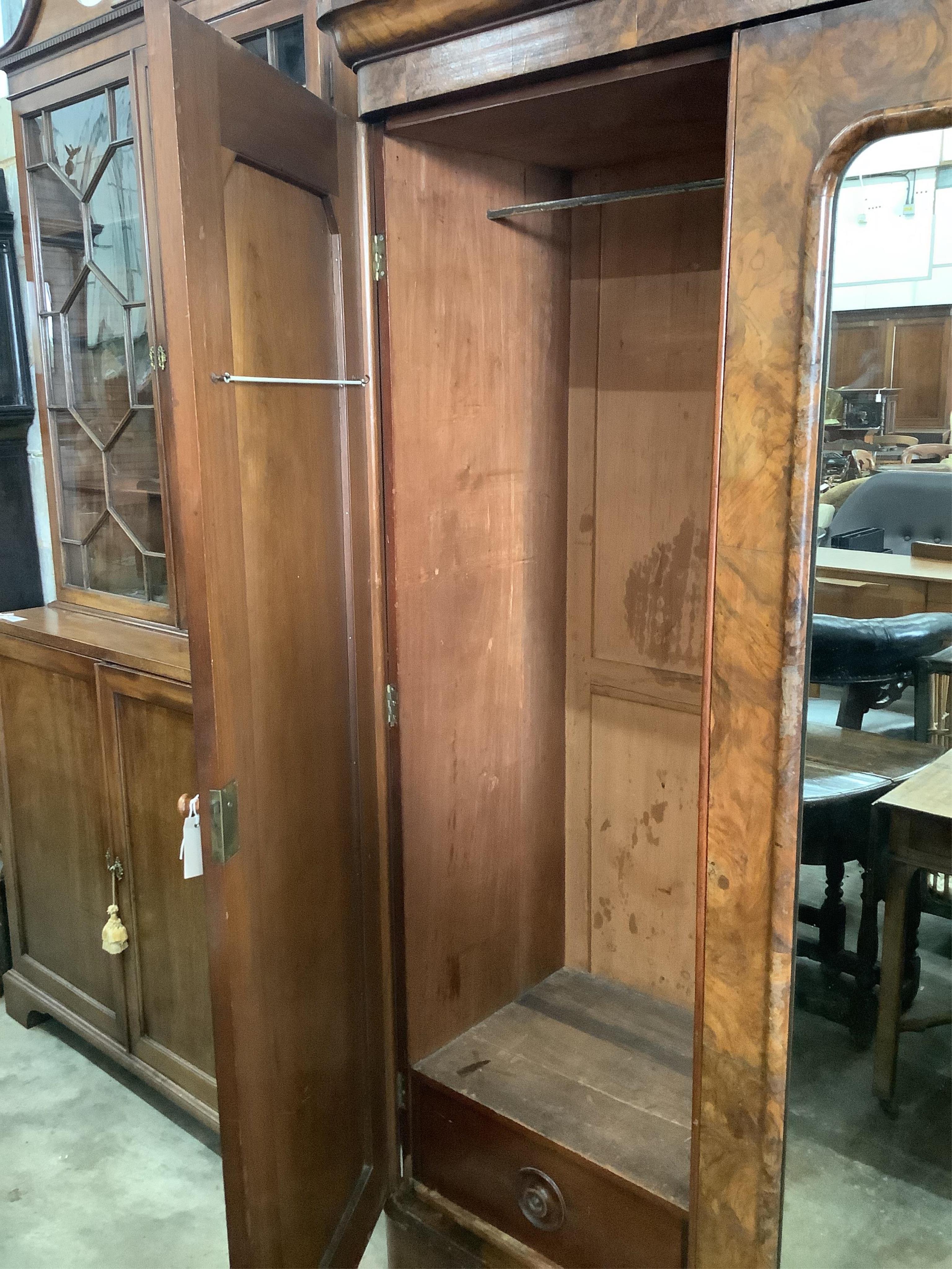 A Victorian figured walnut mirrored compactum wardrobe, width 192cm, depth 49cm, height 208cm. Condition - fair